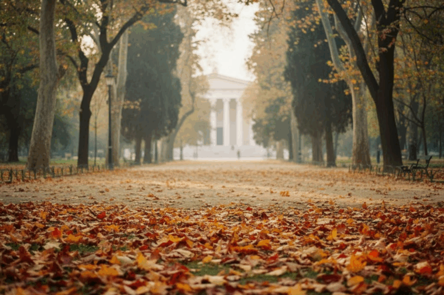 Φθινοπωρινός Εθνικός Κήπος Αθηνών με χρυσά φύλλα στο μονοπάτι και το Ζάππειο στο βάθος